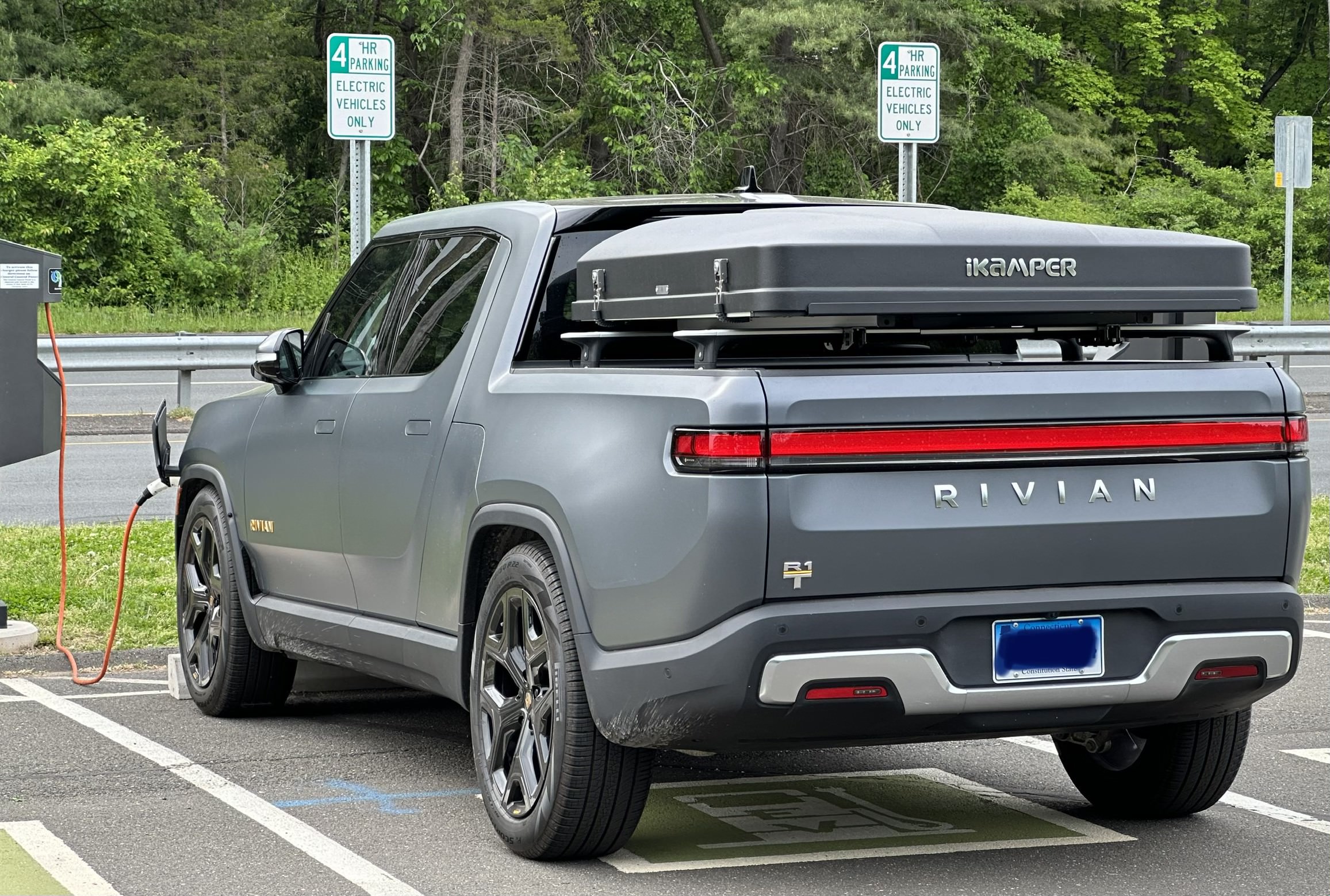 Rivian at Charger with Camper Accessory