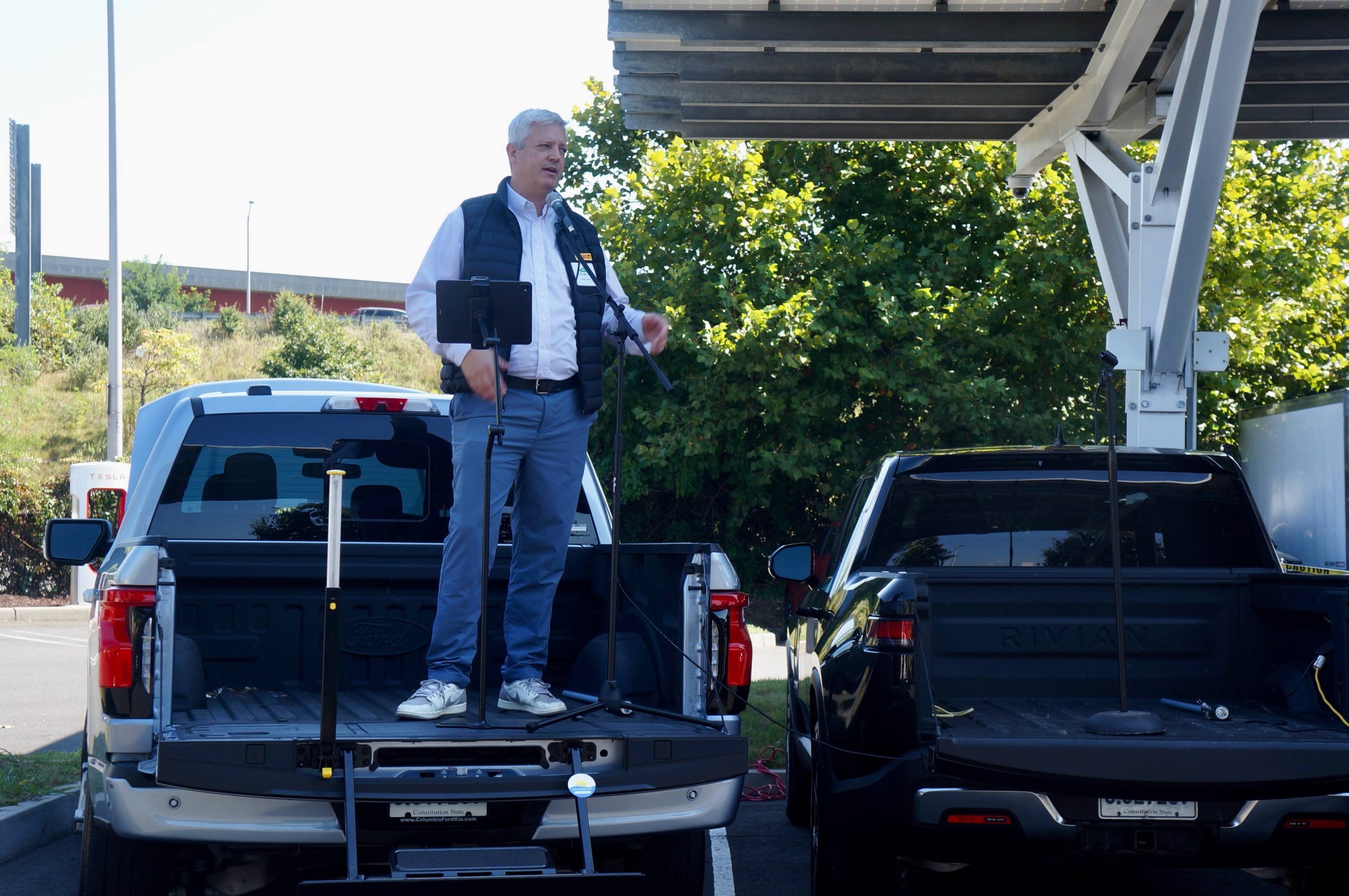 Out of Spec Dave presenting at NorthEast Electric Vehicle Symposium from the bed of a Ford F150 Lightning