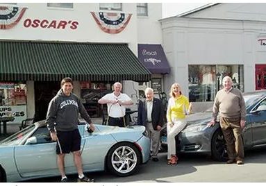 Left to right: Avi Kaner (second selectman), Lee Papageorge (Oscar's owner),Leo Cirino (WECC president), Robin Tauck (her 2 Teslas), Jim Marpe (first selectman) Main Street in front of Oscar's Deli, Saturday, March 22, 2014.
